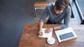 Man-writing-blog-post-in-coffee-shop-small